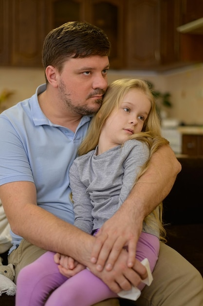 daughter sits on dads lap